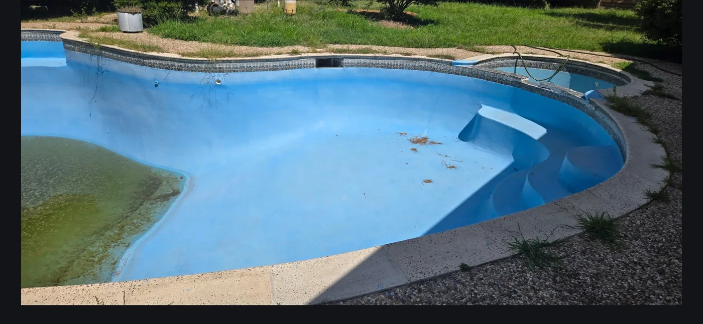 Worn, stained and algae-marked pool plaster before resurfacing by Redzone Pools in Greater Houston